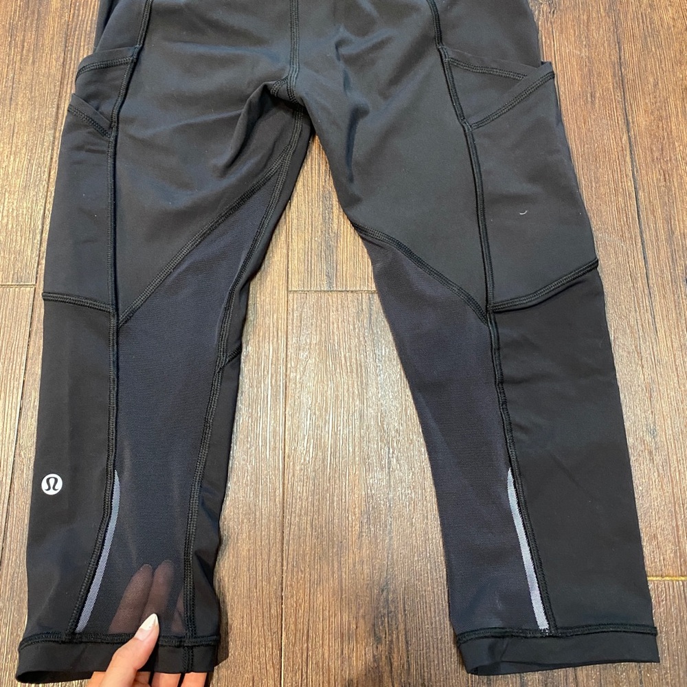 Lululemon black capris w/ pockets and mesh. Size 4